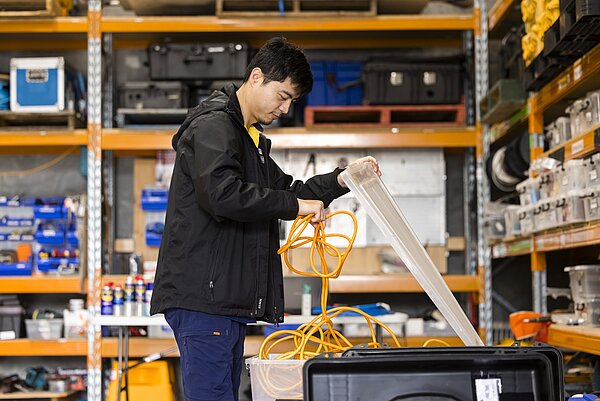 Hydrographic surveyor assembling and preparing marine survey equipment before deployment