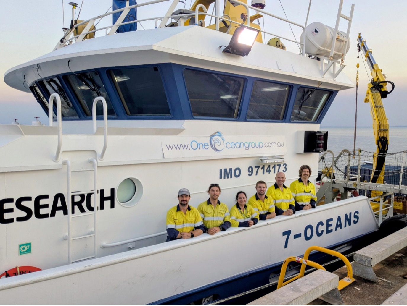 Graduate hydrographic surveyors and survey team aboard an offshore survey vessel