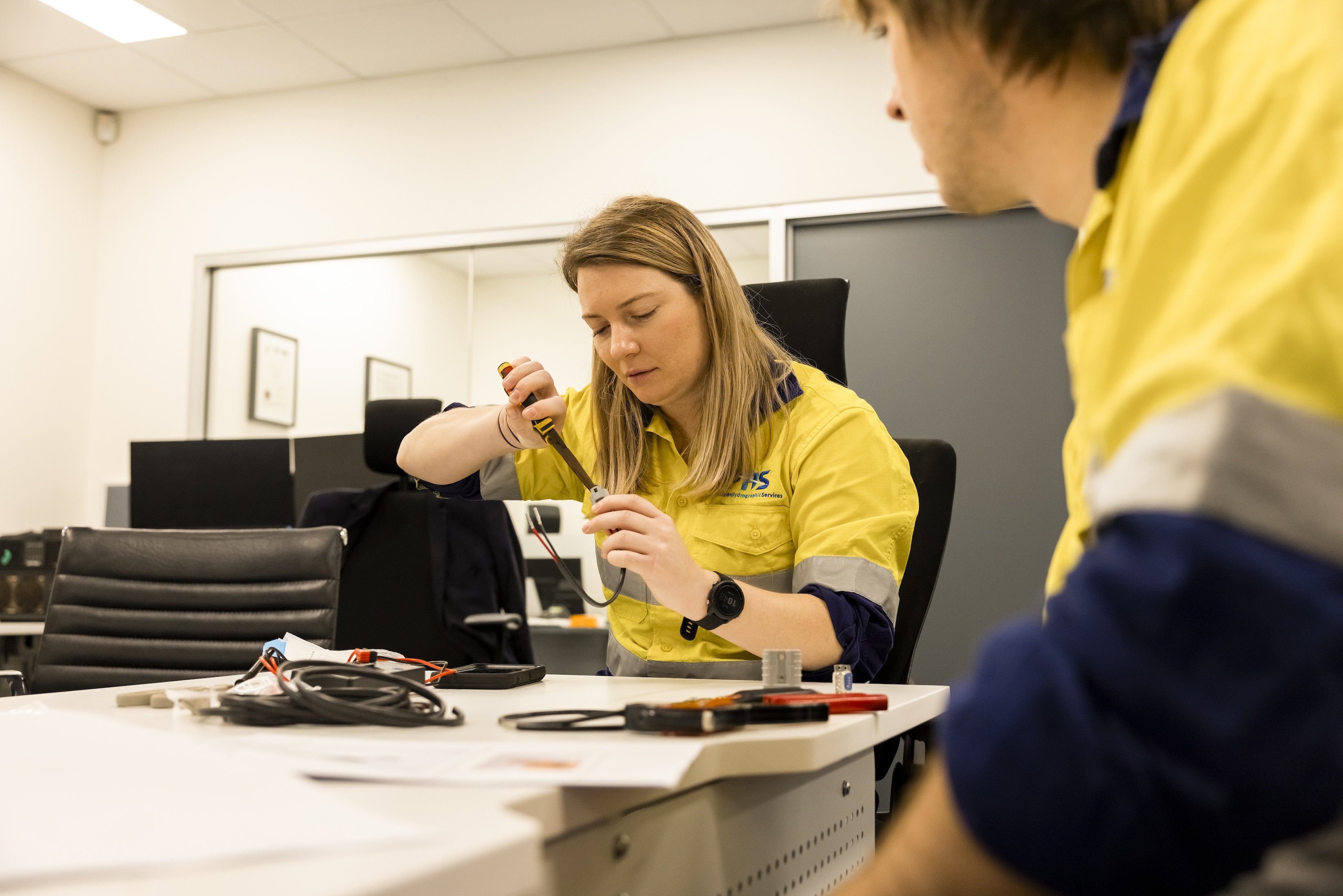 Graduate surveyor developing technical skills during equipment assembly and testing